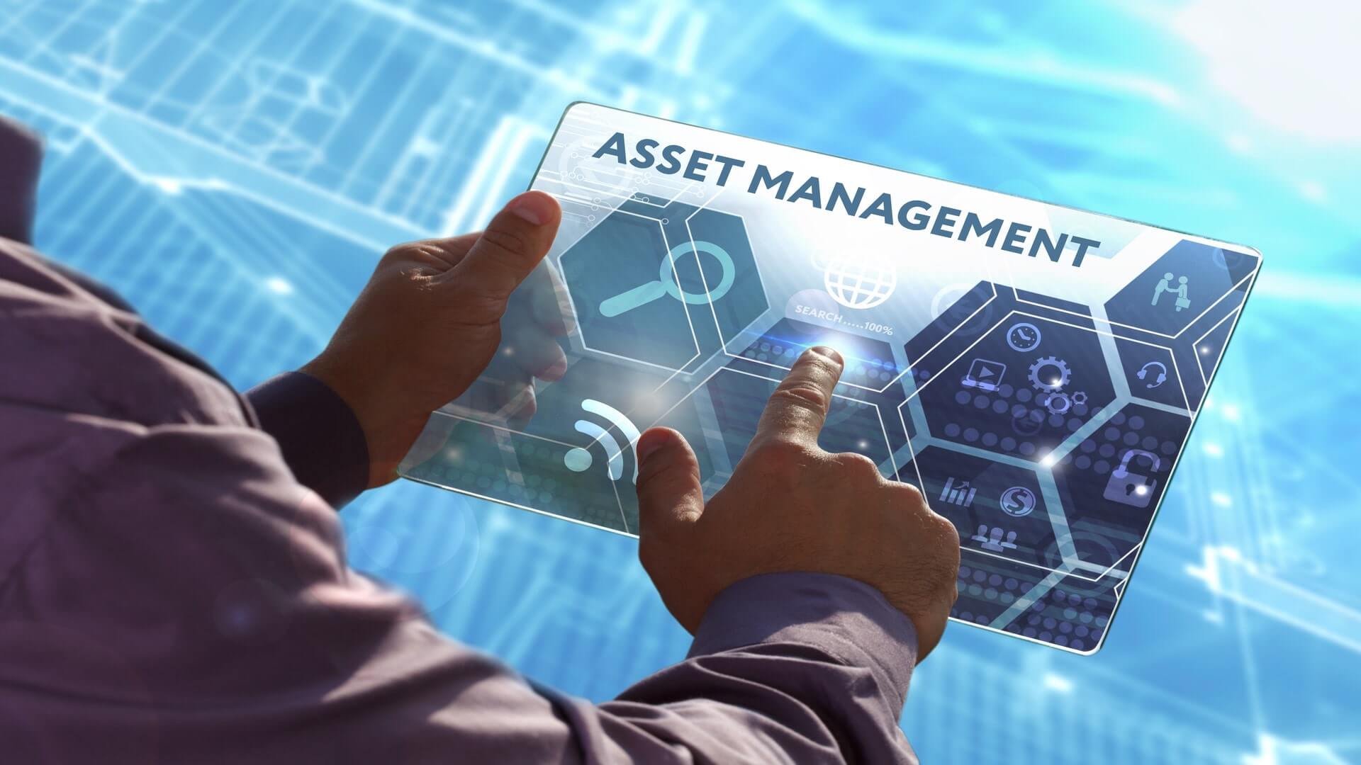 Man clicking a futuristic tablet with icons and the title Asset Management on it